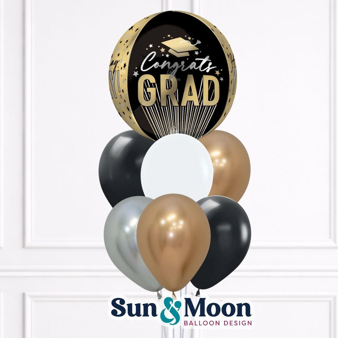 Graduation-themed balloon bouquet with 'Congrats GRAD' text